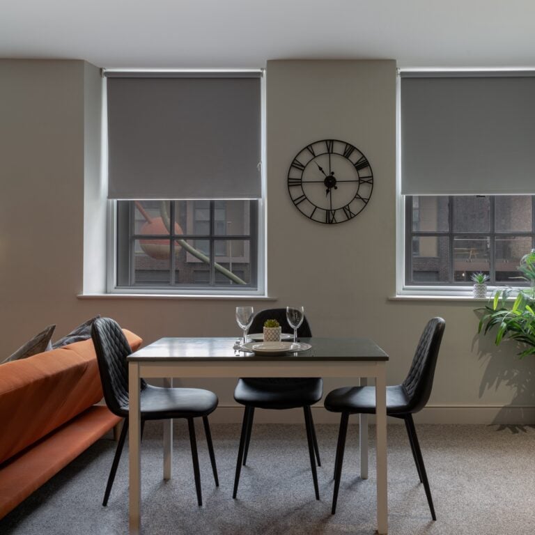 London, Liverpool - Oct 07, 2023 - Comfortable in living room of small apartment with table and chairs, sofa, sink and see the outside view through the windows. Real estate rent and home staging, Interior design, Space for text, Selective focus.